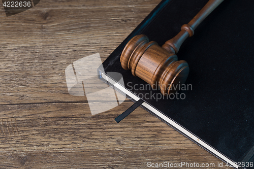 Image of Judge\'s hammer on black folder