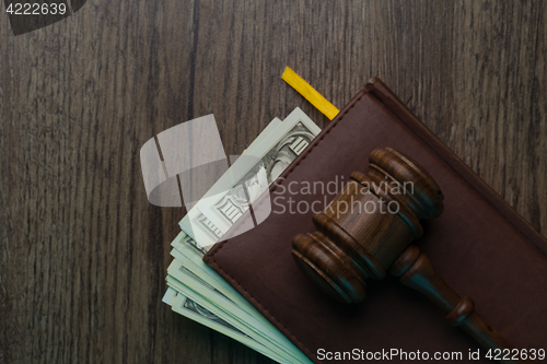 Image of Hammer on folder with banknotes