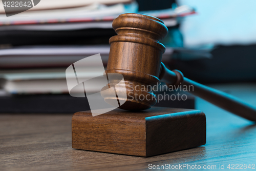 Image of Wooden table with hammer, documents