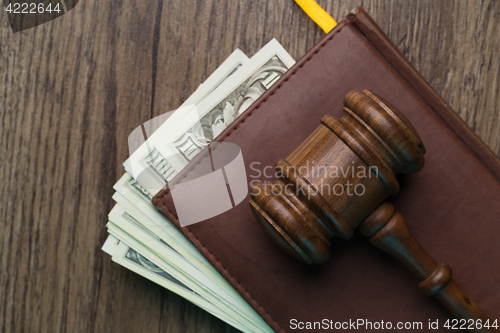 Image of Wooden table with hammer, banknotes