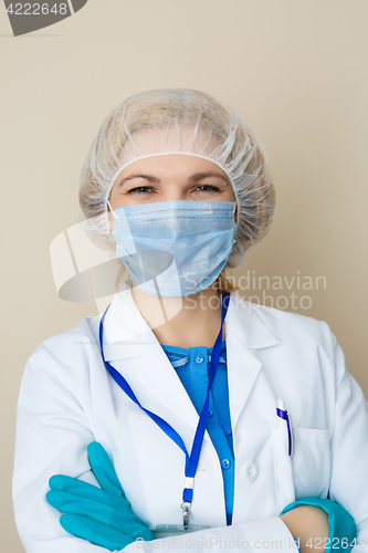 Image of Doctor in mask, gloves, coat