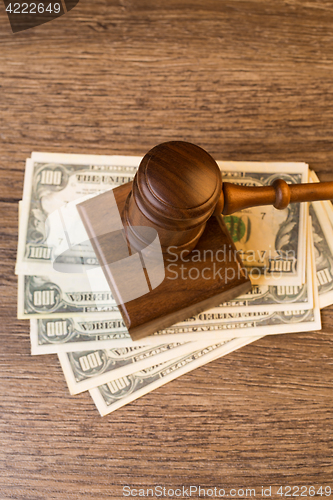 Image of Photo of hammer on money