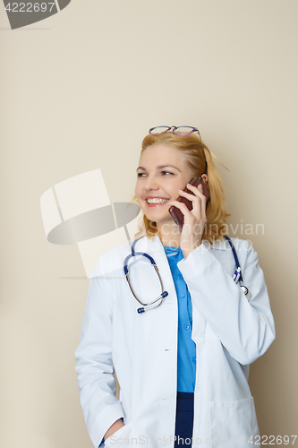 Image of Handsome doctor talking on phone