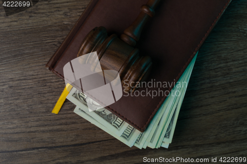 Image of Judge\'s hammer, folder with banknotes