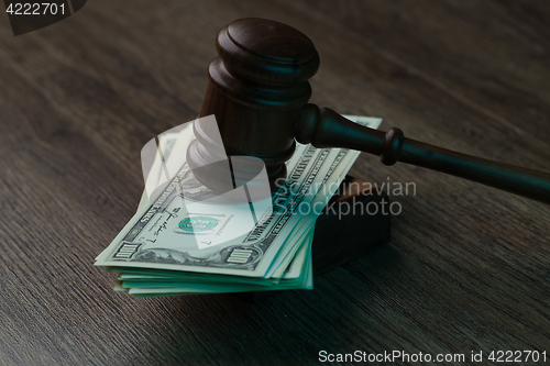 Image of Hammer on dollars at table