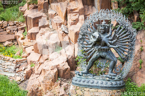 Image of Tantric Deities statue in Ritual Embrace located in a mountain g