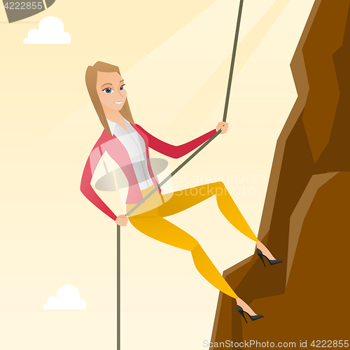 Image of Business woman climbing on the mountain.