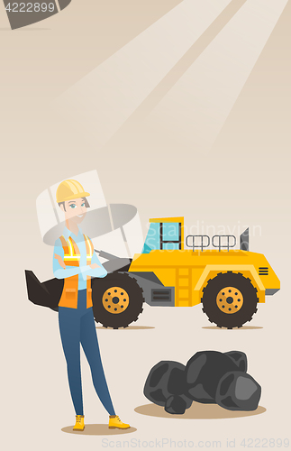 Image of Miner with a big excavator on background.