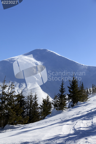 Image of Snow winter mountains at sun windy day