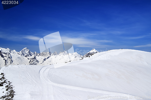 Image of Off-piste slope for freeriding with track from snow grooming in 