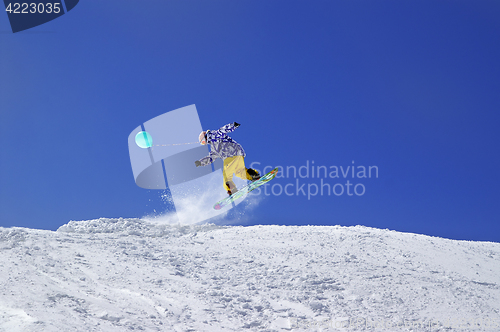 Image of Snowboarder jump with toy balloon in terrain park at ski resort 