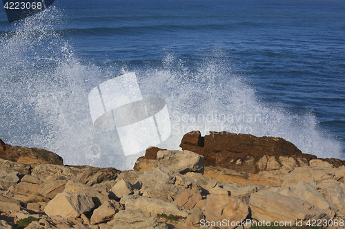 Image of Marine wave breaks against offshore stone