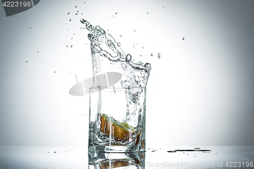 Image of water splash in glass of gray color