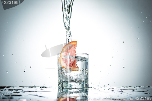 Image of water splash in glass of gray color