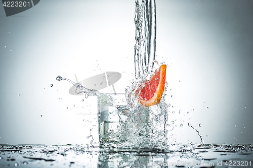 Image of water splash in glass of gray color