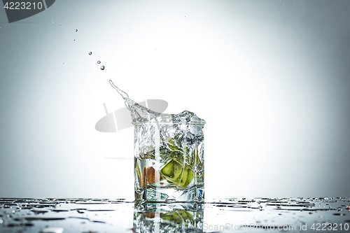 Image of water splash in glass of gray color