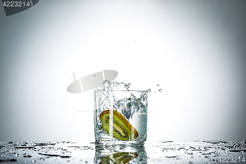 Image of water splash in glass of gray color