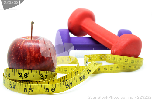 Image of Dumbbell with measuring tape and red apple