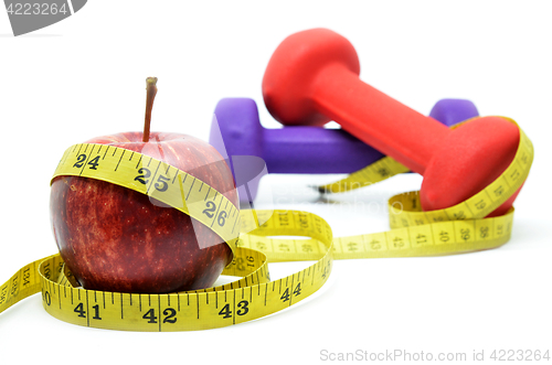 Image of Dumbell with measuring tape and red apple