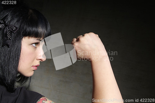 Image of woman clenches fist