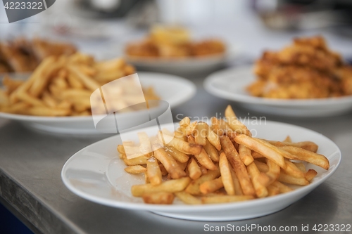 Image of French fries and meat on the table