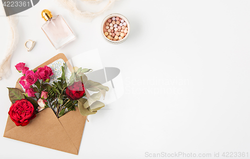 Image of Love or valentine\'s day concept. Red beautiful roses in envelopen