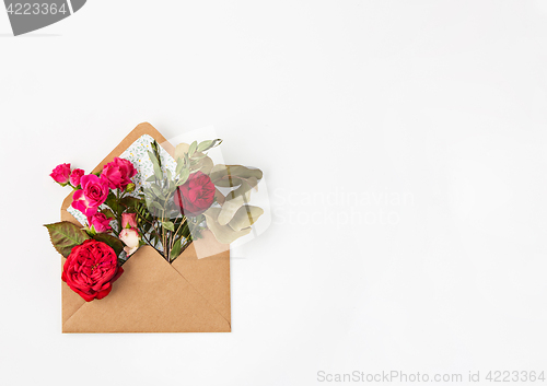 Image of Love or valentine\'s day concept. Red beautiful roses in envelopen