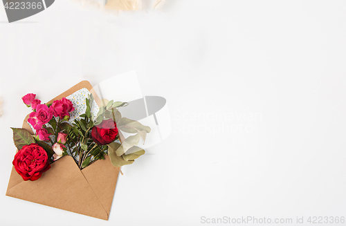 Image of Love or valentine\'s day concept. Red beautiful roses in envelopen