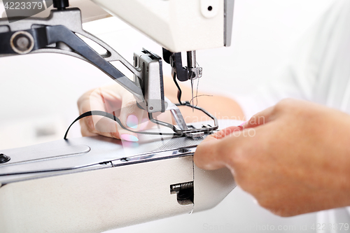 Image of Constructor. Sewing on a machine.  Sewing machine  Sewing. Sewing machine 