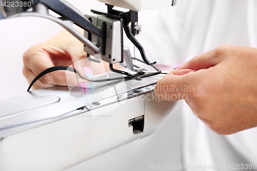 Image of Factory, sewing room. Production of apparel. Occupation needlewoman.