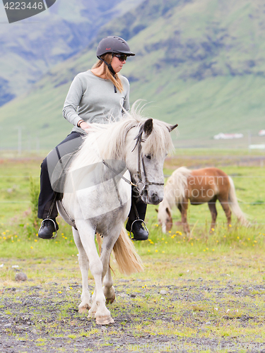 Image of Woman riding a horse