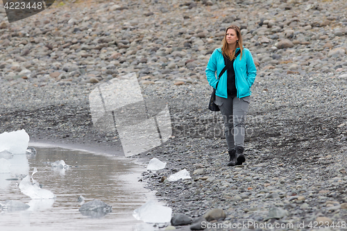 Image of Woman walking over the beach at Jokulsarlon glacier lagoon - Ice