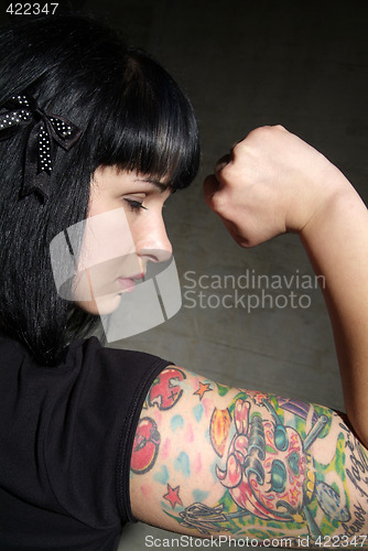 Image of woman with tattoo and fist