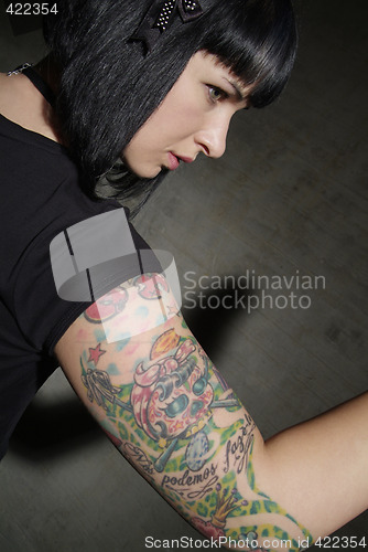 Image of woman with tattooed arm