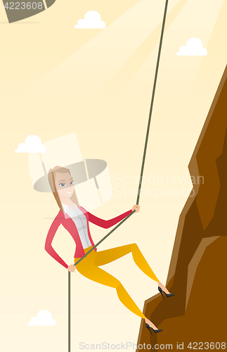 Image of Business woman climbing on the mountain.