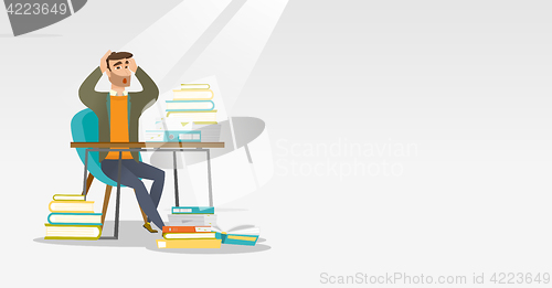 Image of Student sitting at the table with piles of books.