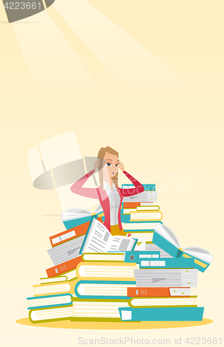 Image of Student sitting in huge pile of books.