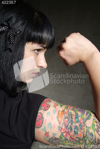 Image of woman with tattoo and fist