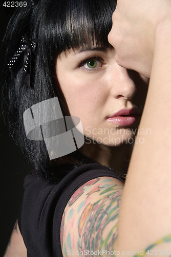 Image of woman with tattoo and fist