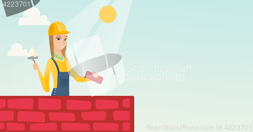 Image of Bricklayer working with spatula and brick.