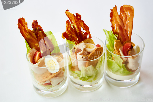 Image of Caesar Salad, served in glass.