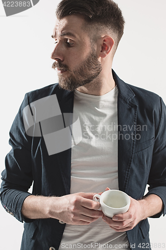 Image of Portrait of stylish handsome young man with cup of coffee