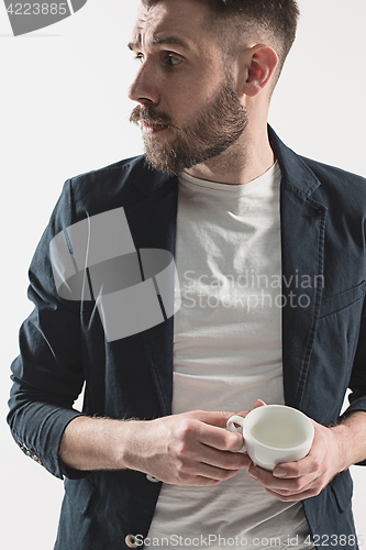 Image of Portrait of stylish handsome young man with cup of coffee