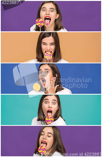 Image of young woman with the colorful lollipop at studio