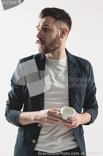 Image of Portrait of stylish handsome young man with cup of coffee