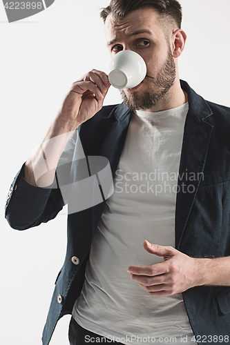 Image of Portrait of stylish handsome young man with cup of coffee