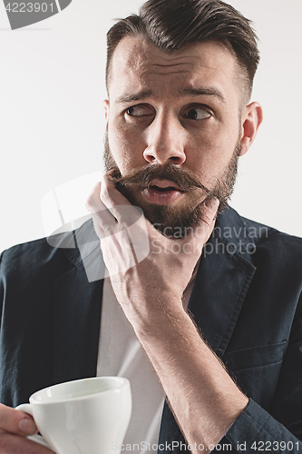 Image of Portrait of stylish handsome young man with cup of coffee