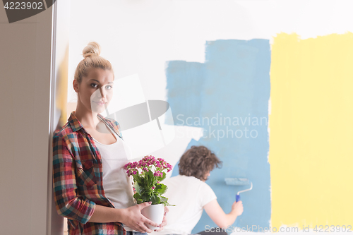 Image of happy young couple doing home renovations