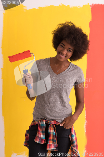 Image of black woman painting wall