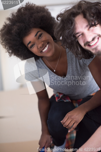 Image of multiethnic couple renovating their home